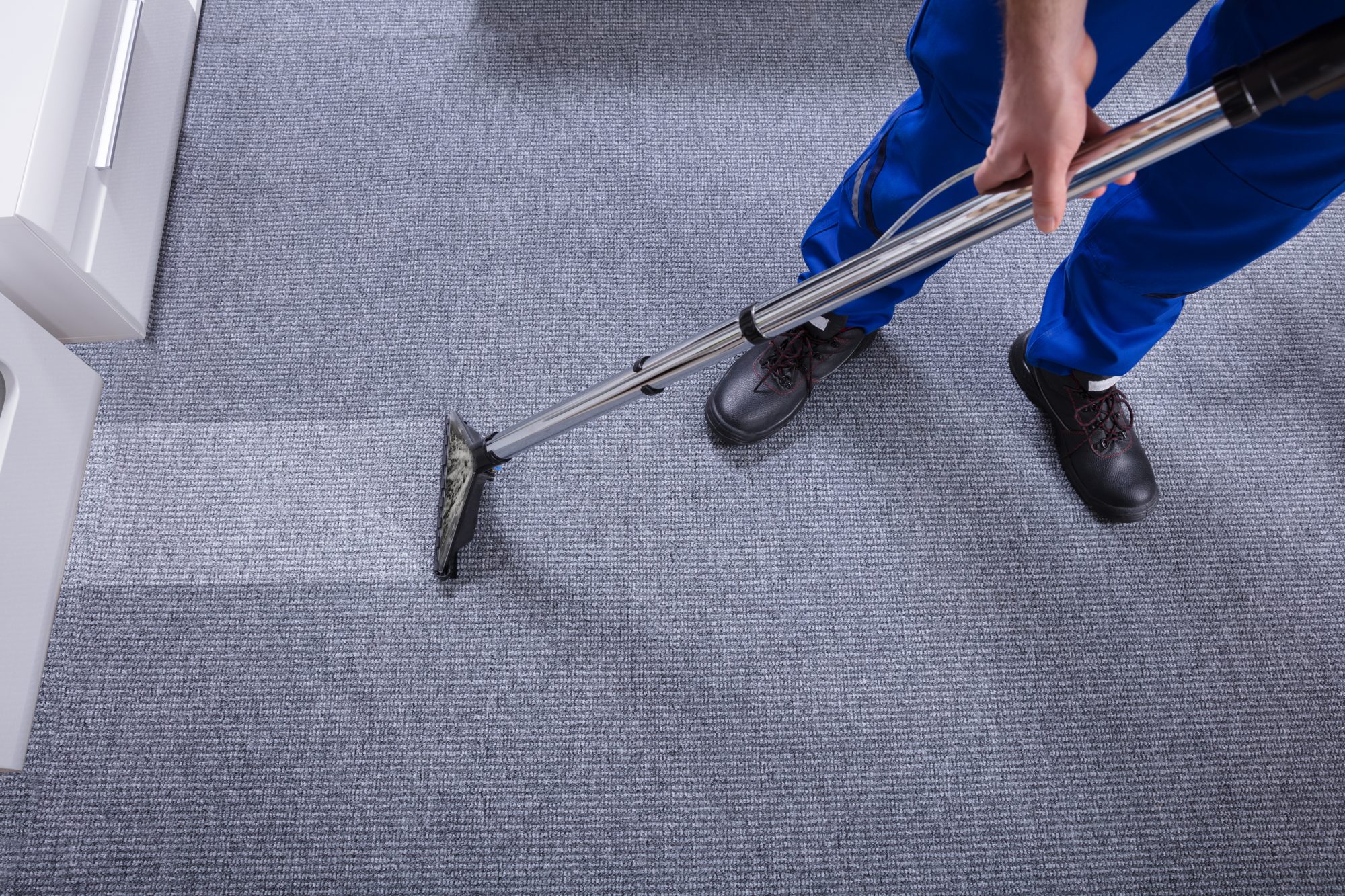 Janitor`s Hand Cleaning Carpet With Vacuum Cleaner